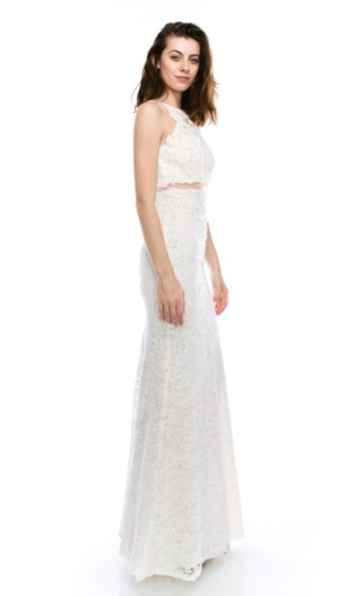A woman poses in the Mock Two-Piece Long Lace Prom Dress (Chicas CR4225), a sleeveless, floor-length embroidered lace gown with a fitted bodice, radiating timeless elegance against a plain white background.